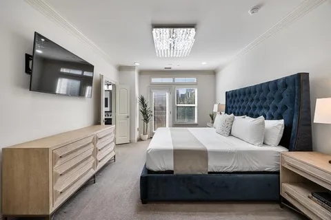 a bedroom with a bed and a television