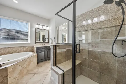 a bathroom with a granite countertop sink a toilet and bathtub