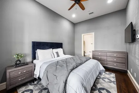 a bedroom with a bed and a flat screen tv