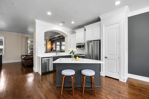 a kitchen with refrigerator cabinets dining table and chairs