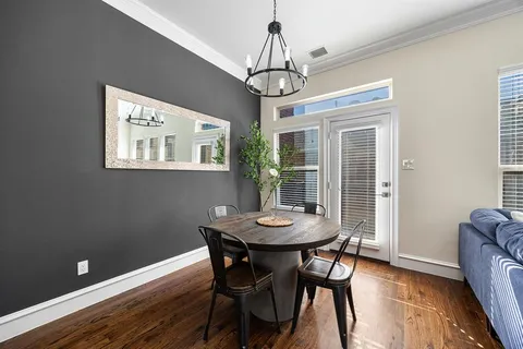 a view of a dining room with furniture window and wooden floor
