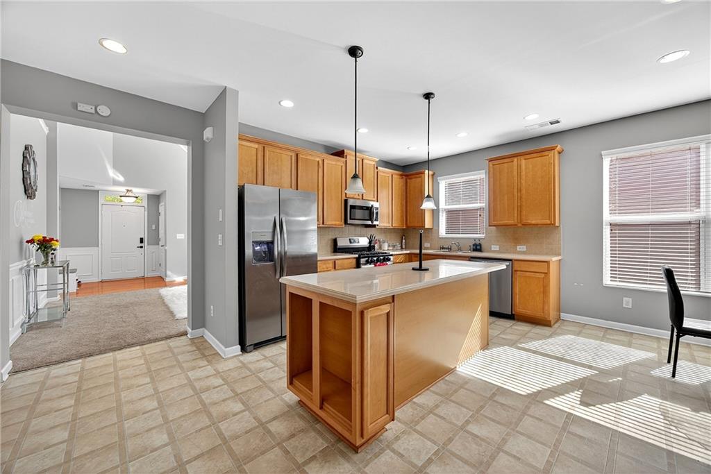 4249 Rosehall Court Atlanta, GA 30349 - Photo 11 of 28 a kitchen with stainless steel appliances granite countertop a refrigerator a sink a stove and oven