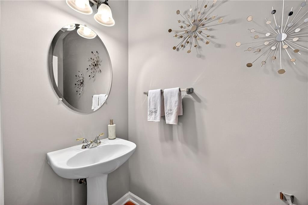 4249 Rosehall Court Atlanta, GA 30349 - Photo 12 of 28 a bathroom with a sink and a mirror