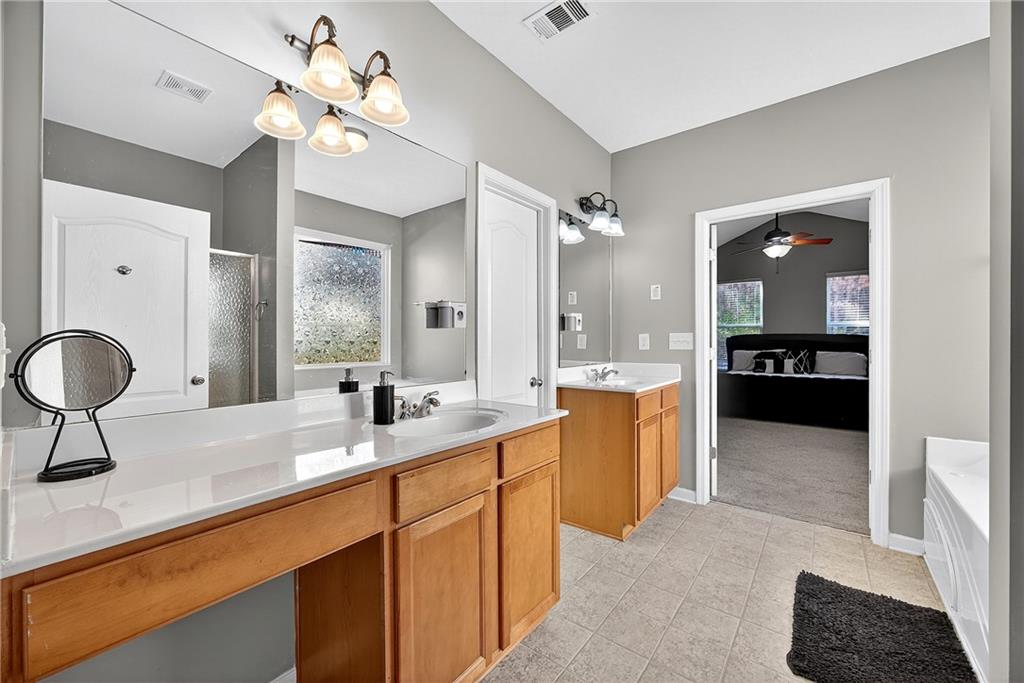 4249 Rosehall Court Atlanta, GA 30349 - Photo 16 of 28 a large kitchen with kitchen island a sink stainless steel appliances and cabinets
