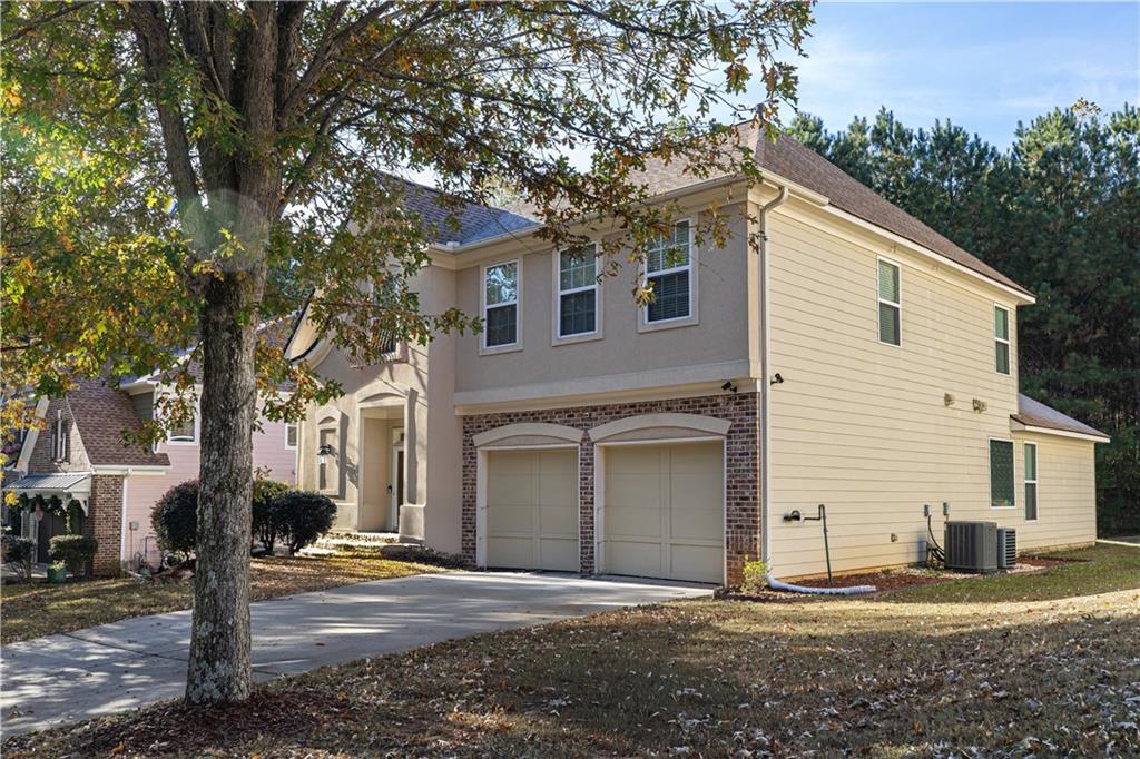4249 Rosehall Court Atlanta, GA 30349 - Photo 2 of 28 a white house with a large tree next to a road