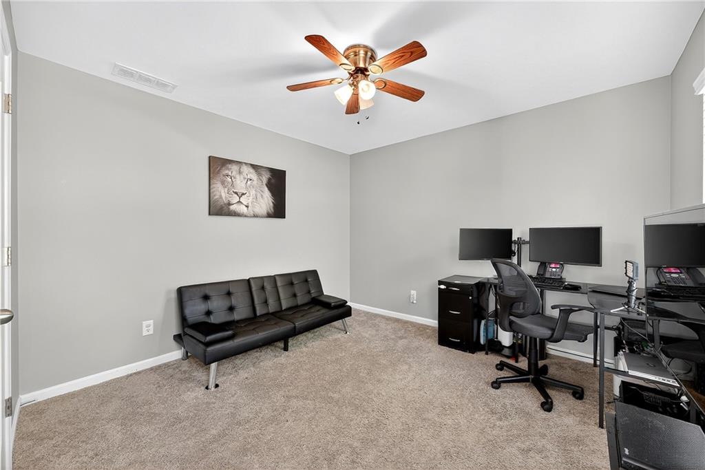 4249 Rosehall Court Atlanta, GA 30349 - Photo 21 of 28 a living room with furniture and a flat screen tv