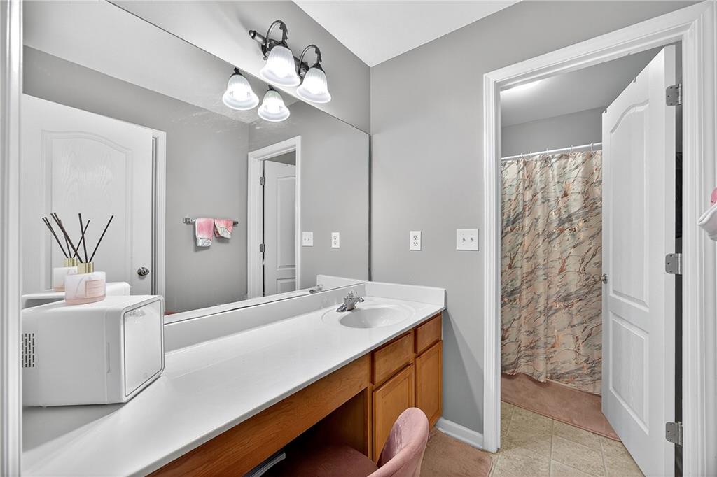 4249 Rosehall Court Atlanta, GA 30349 - Photo 22 of 28 a bathroom with a sink a double vanity and a mirror