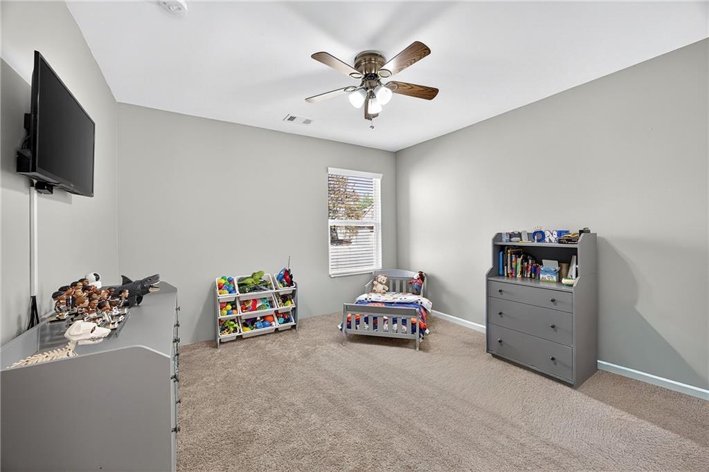 4249 Rosehall Court Atlanta, GA 30349 - Photo 24 of 28 a bedroom with furniture and a flat screen tv