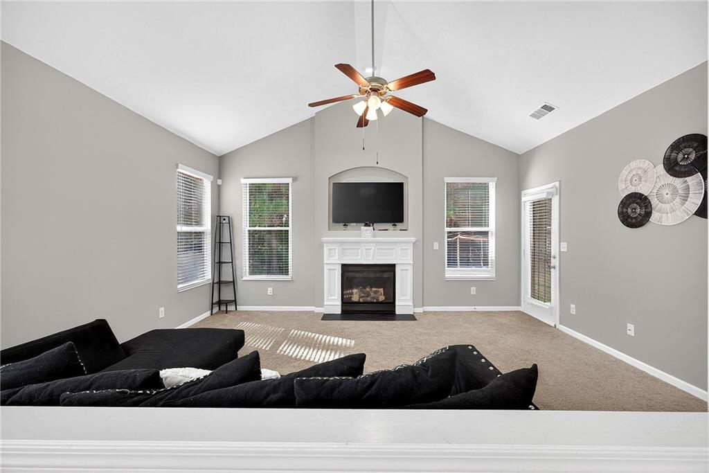 4249 Rosehall Court Atlanta, GA 30349 - Photo 4 of 28 a living room with furniture and a fireplace