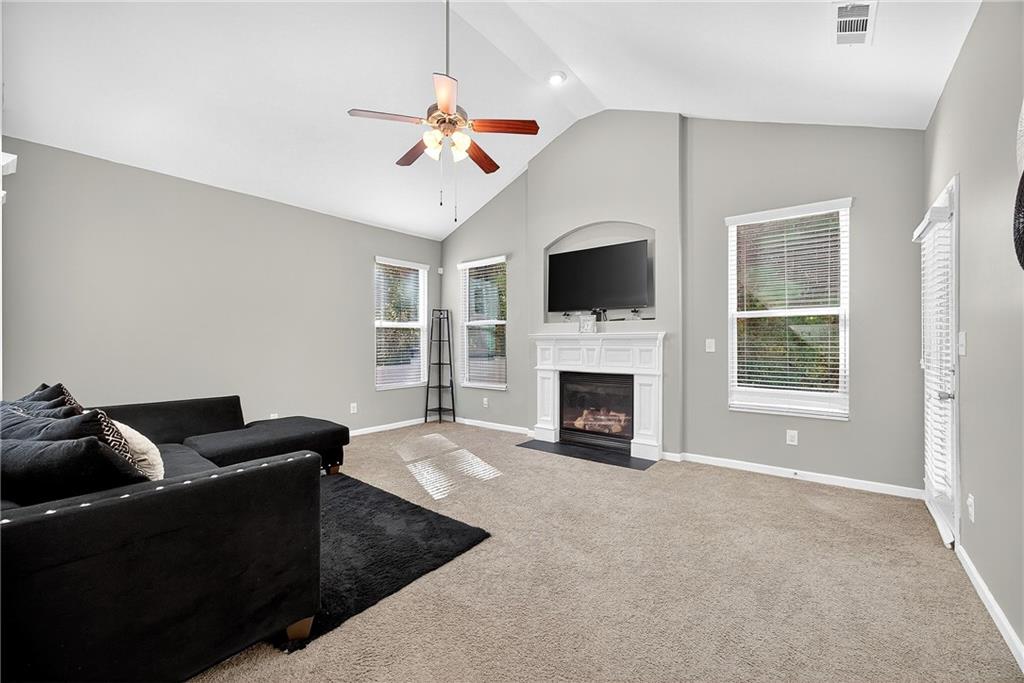 4249 Rosehall Court Atlanta, GA 30349 - Photo 5 of 28 a living room with furniture a fireplace and a flat screen tv