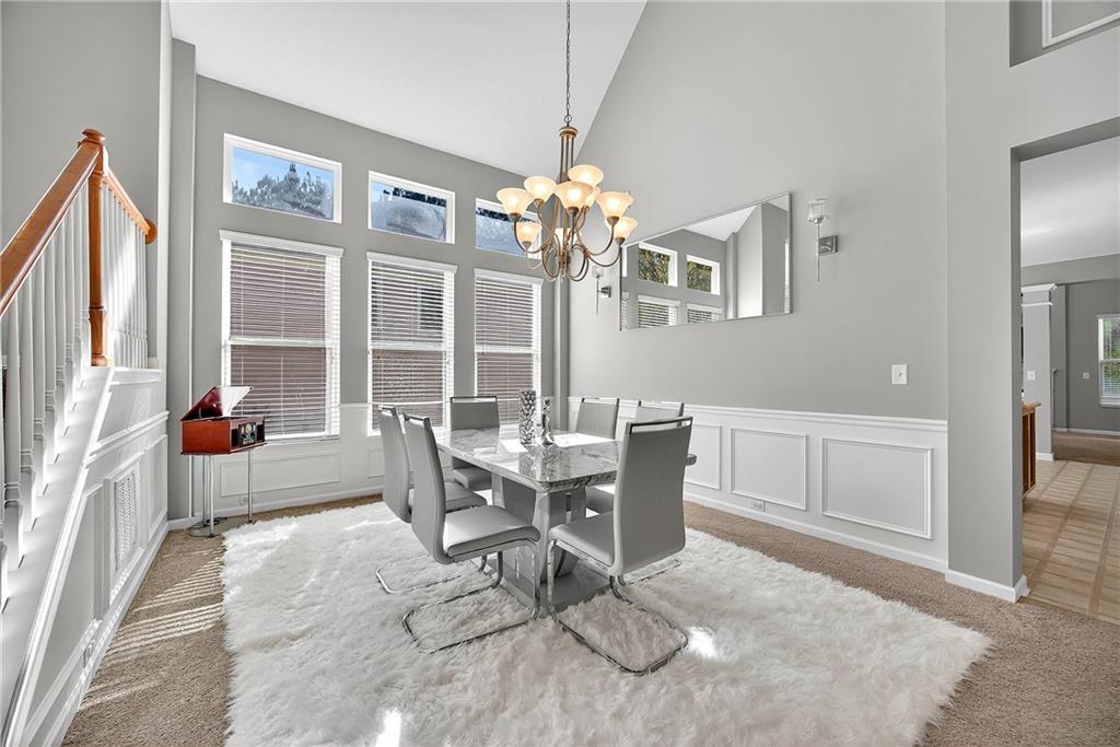 4249 Rosehall Court Atlanta, GA 30349 - Photo 7 of 28 a work room with furniture a large window and a chandelier
