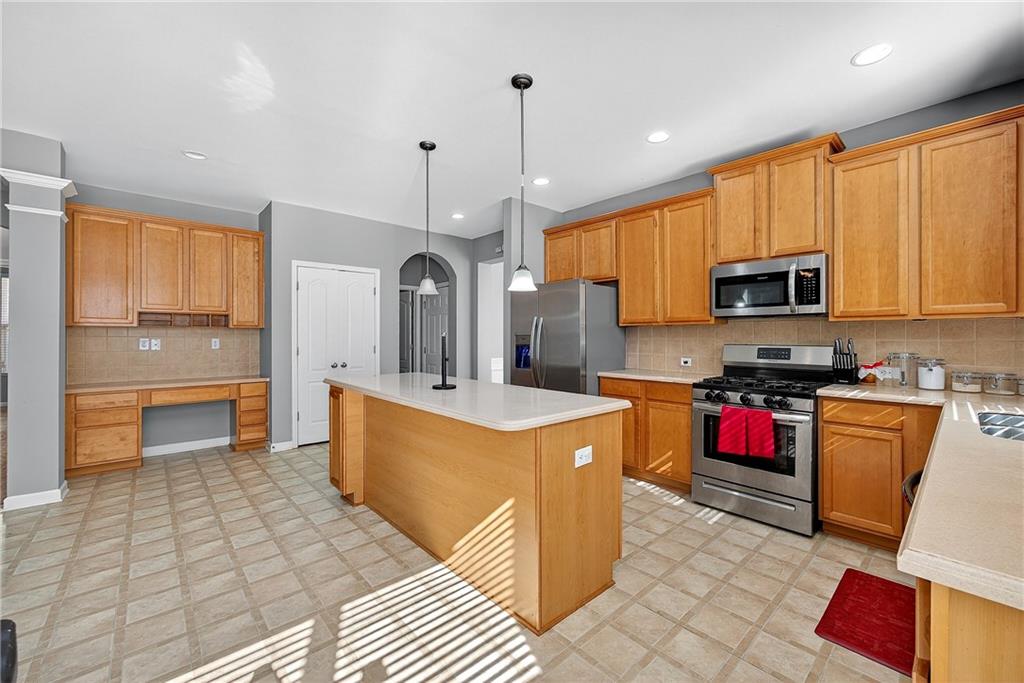 4249 Rosehall Court Atlanta, GA 30349 - Photo 9 of 28 a kitchen with granite countertop a stove top oven microwave and cabinets