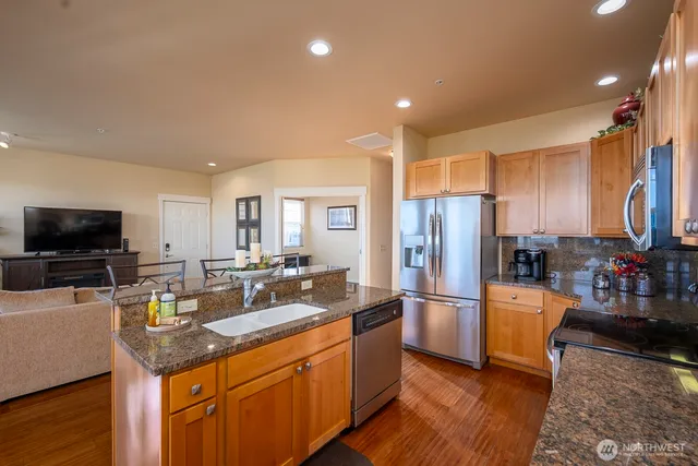 a kitchen with refrigerator and cabinets