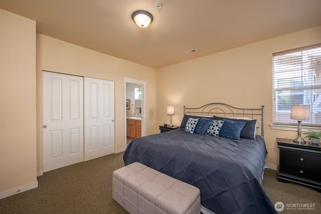 a bedroom with a bed and a lamp