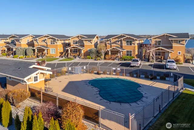a view of multiple houses with a swimming pool