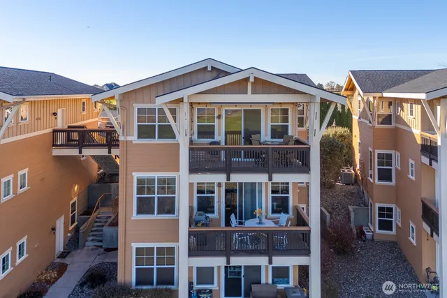 a front view of a residential apartment building with a yard