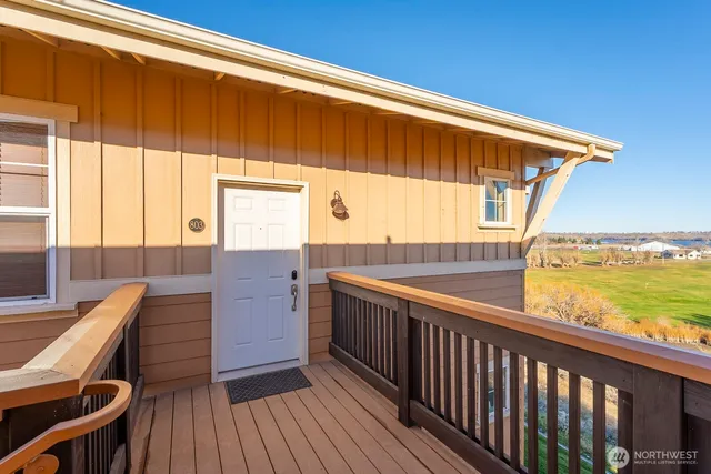 a view of balcony with wooden floor and outdoor seating