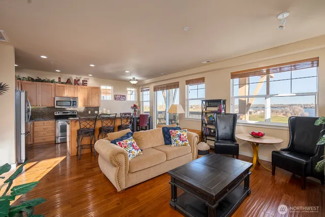 a living room with furniture and kitchen view