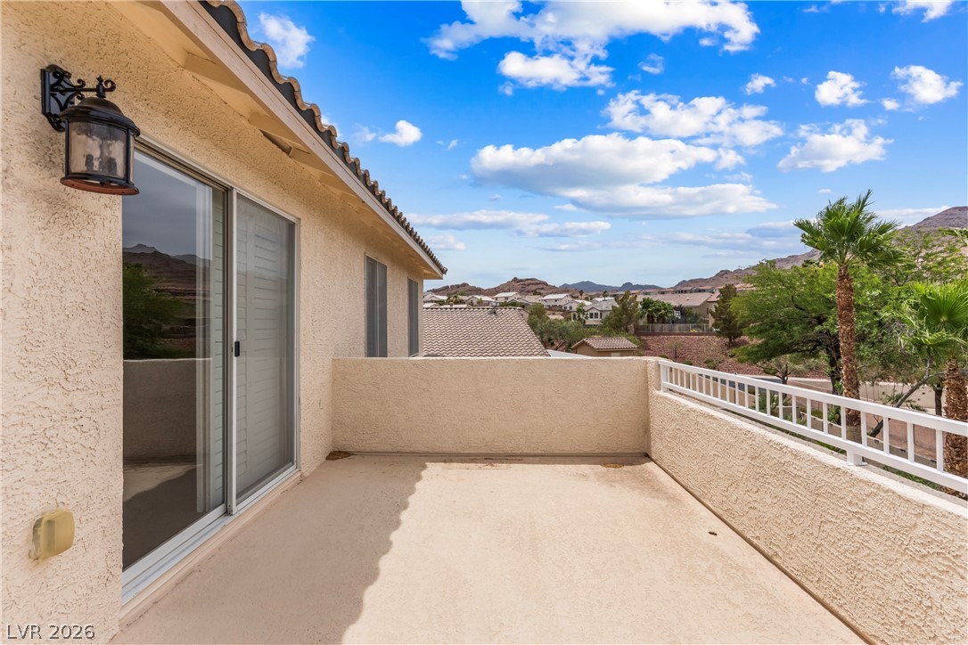 708 Vortex Avenue Henderson, NV 89002 - Photo 38 of 71 A spacious balcony overlooks desert mountains and a neighborhood below, perfect for outdoor enjoyment.
