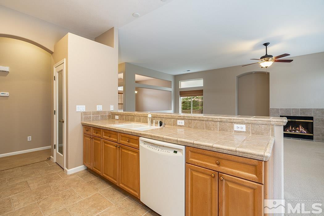 1748 Arrow Wood Court Reno, NV 89521 - Photo 8 of 19 a kitchen with a sink and a refrigerator