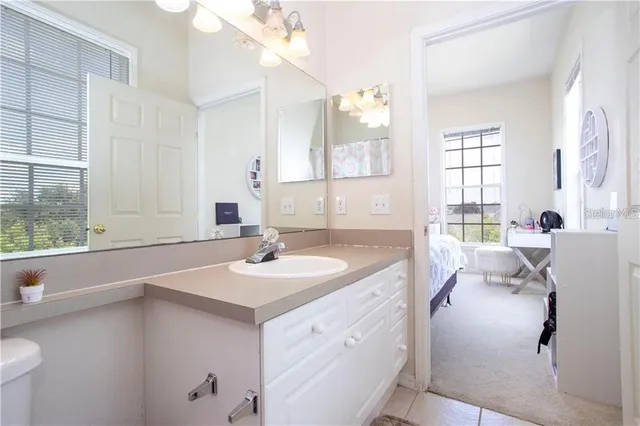 a en suite bathroom with a sink and a large mirror