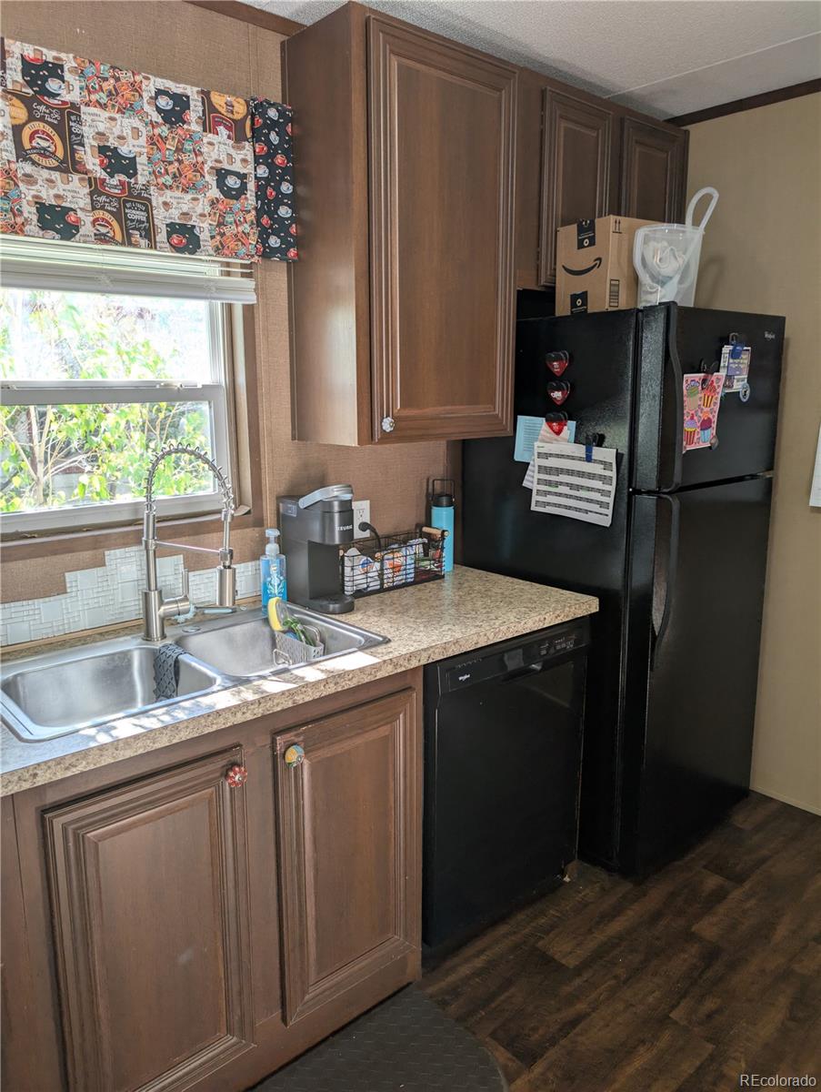 19 Danny Street Castle Rock, CO 80109 - Photo 11 of 33 a kitchen with stainless steel appliances granite countertop a sink stove and refrigerator