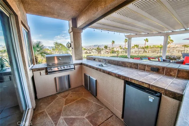 a kitchen with stainless steel appliances granite countertop a sink and a large window