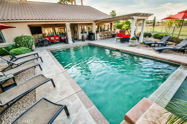 a swimming pool view with a outdoor seating