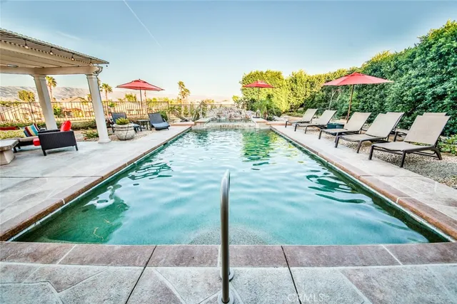 a view of swimming pool with a lounge chair