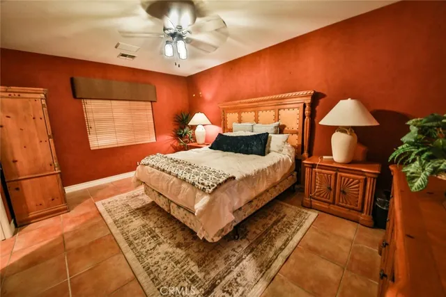 a bedroom with a bed a lamp and a chandelier