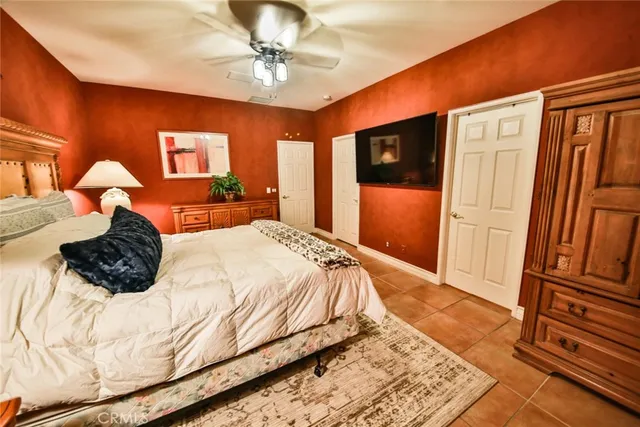 a bedroom with a large bed and a chandelier