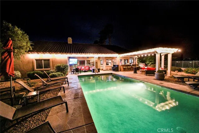 a view of a backyard with swimming pool