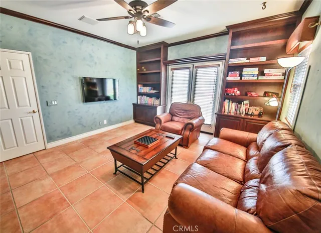 a living room with furniture a ceiling fan and a rug