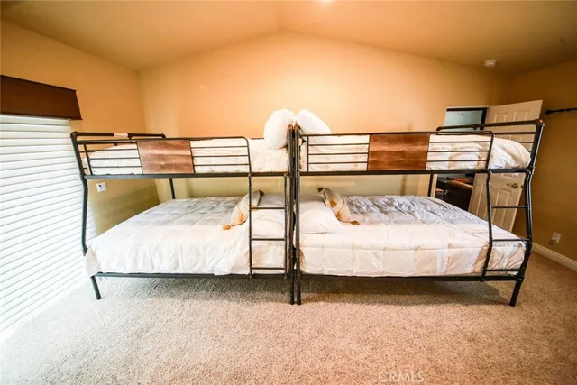 a bedroom with a bed and with view of cupboard