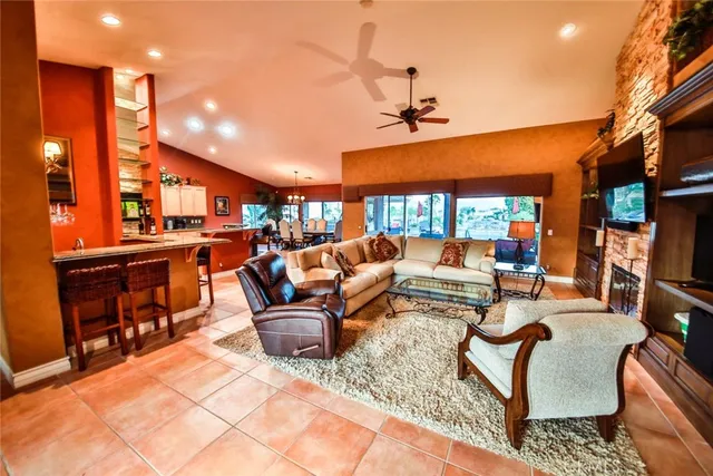 a living room with furniture a ceiling fan and a rug