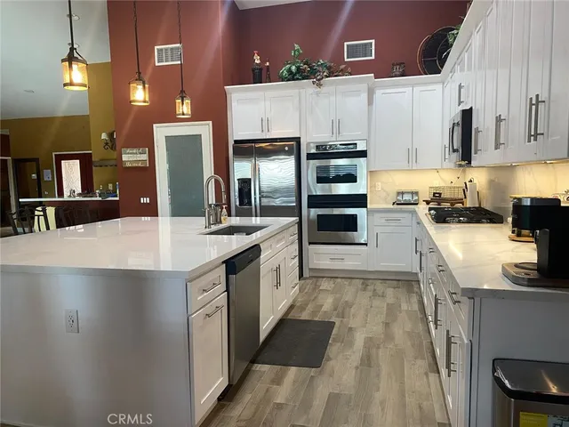 a kitchen with cabinets and stainless steel appliances