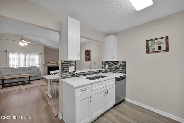 a kitchen with a stove and white cabinets