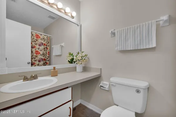 a bathroom with a sink toilet and a mirror