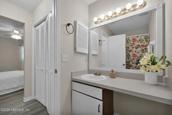 a bathroom with a sink a mirror and a shower