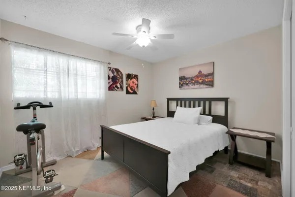 a bedroom with a bed and a chandelier