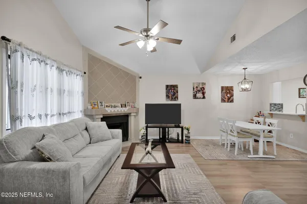 a living room with furniture and a chandelier