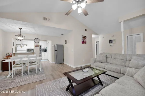 a living room with furniture and wooden floor