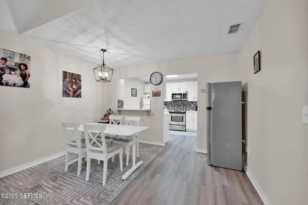 a view of a dining room with furniture and wooden floor