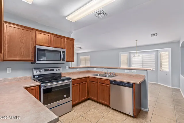 a kitchen with a sink stove and microwave