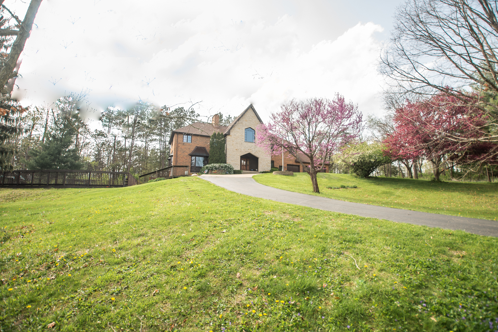 a view of a house with a big yard and potted plants