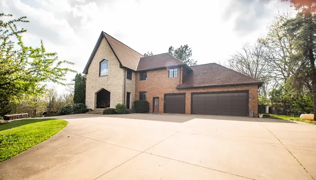 a view of a hallway with wooden floor and a kitchen