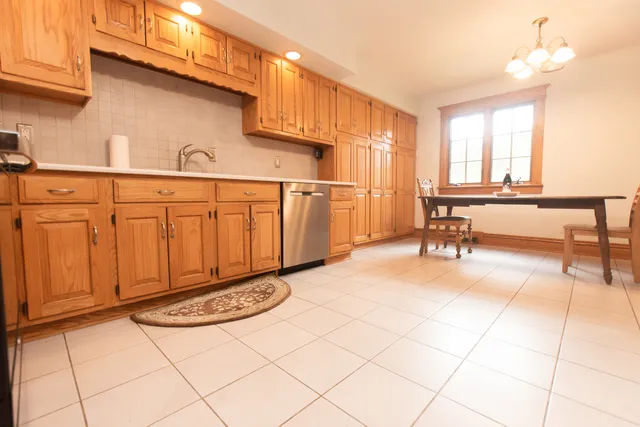a view of an empty room with closet and a window