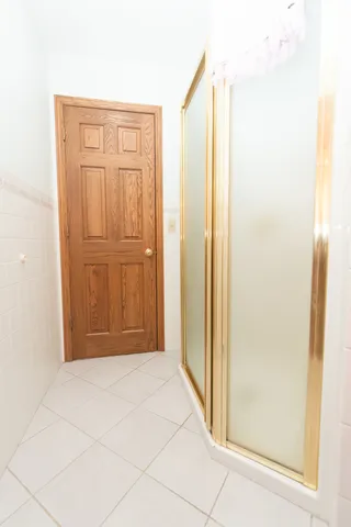 an empty room with closet and a chandelier fan
