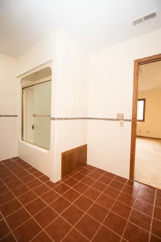 an aerial view of residential house with outdoor space and trees all around