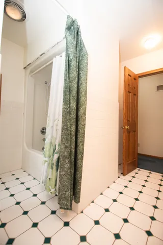 an aerial view of a house with a yard and trees
